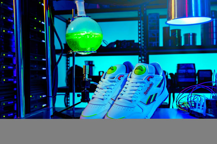 View of white and green Reebok shoes.